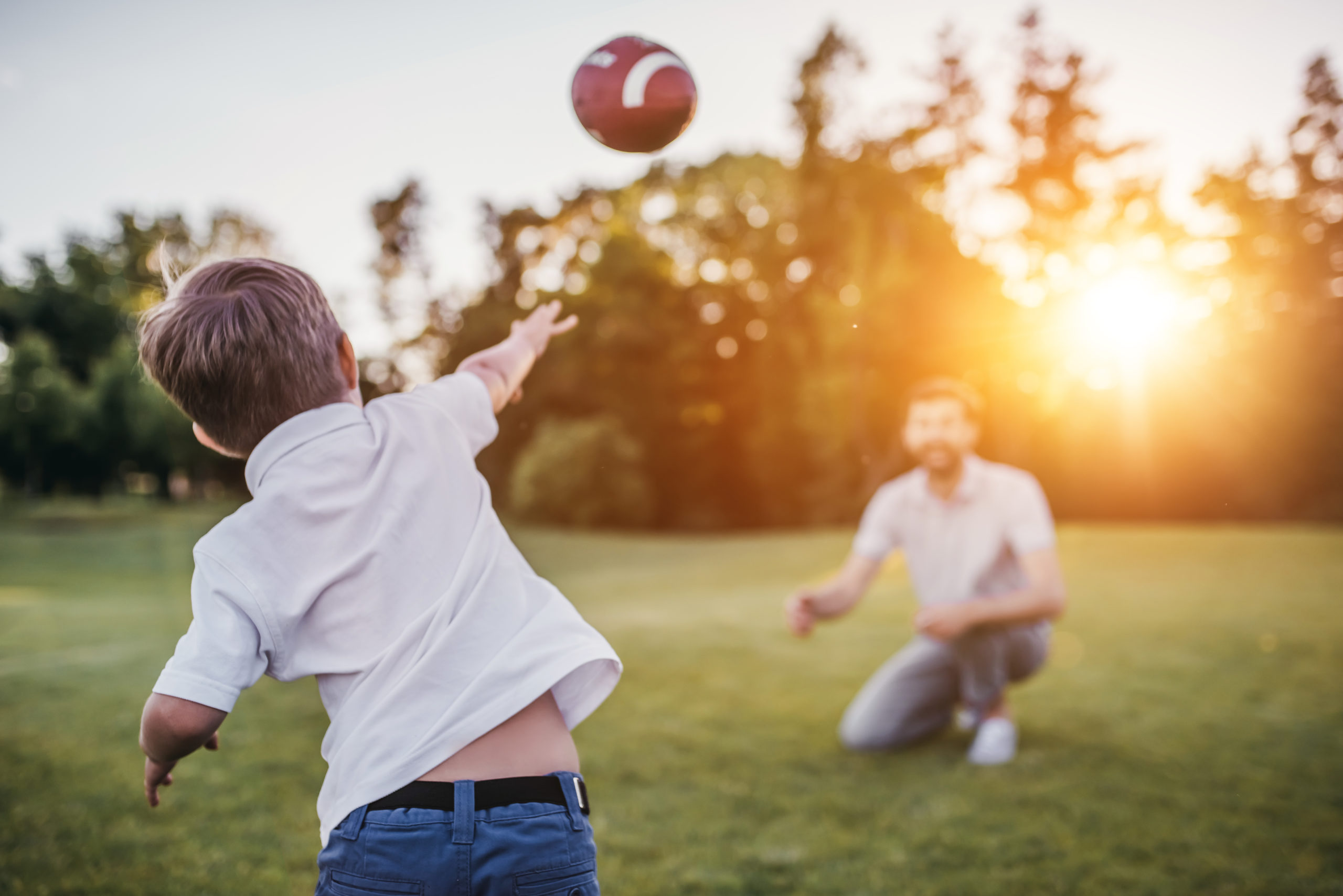 Dad with son playing American football