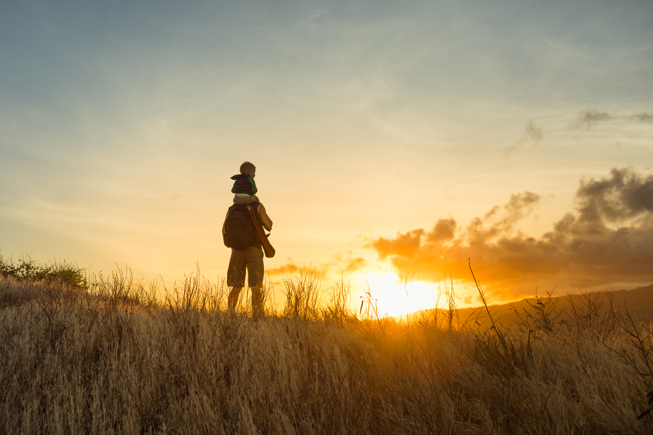 how to deal with summer visitation as a dad: father and son watching sunset